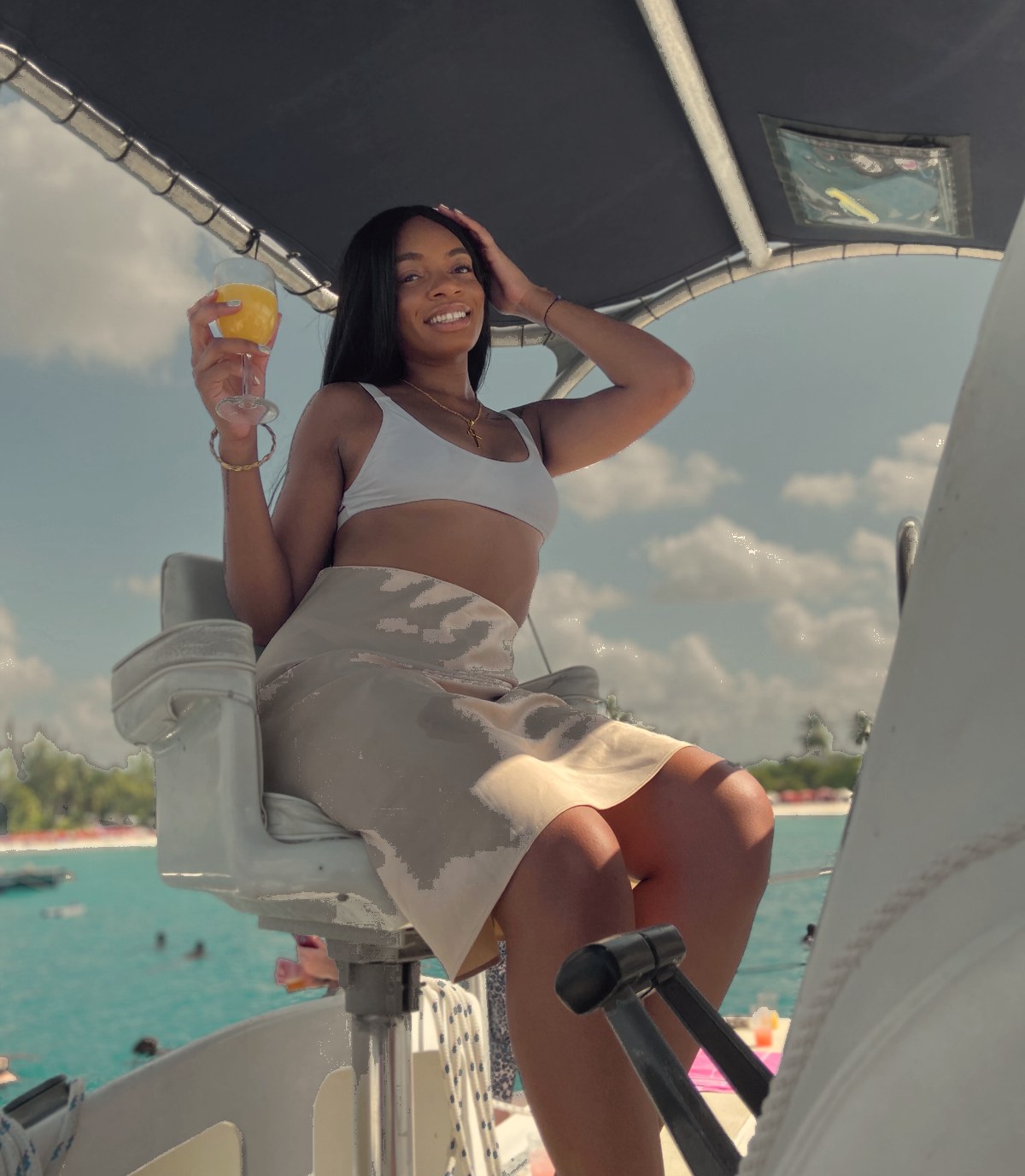 Cassoleil smiling on a boat with a mimosa